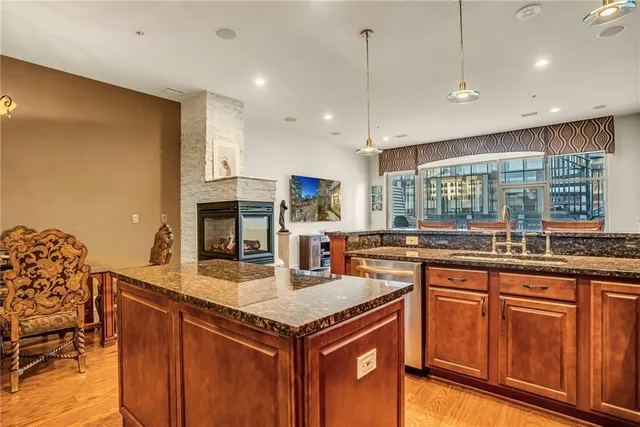 a kitchen with granite countertop a sink and cabinets