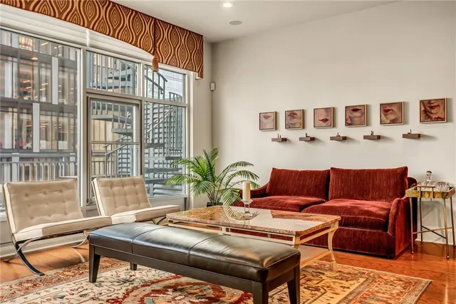 a living room with furniture and a potted plant