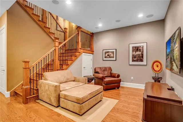 a living room with white walls and a table with wooden floor