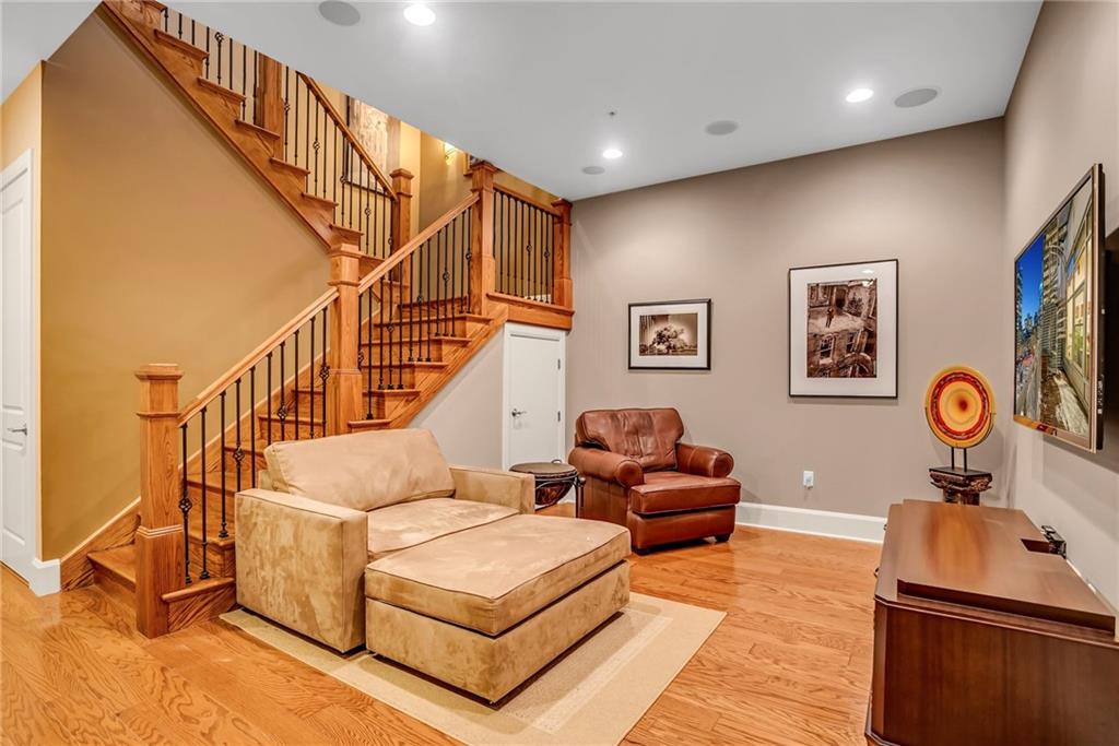 301 Fifth Avenue, Unit 702 Pittsburgh, PA 15222 - Photo 29 of 50 a living room with white walls and a table with wooden floor