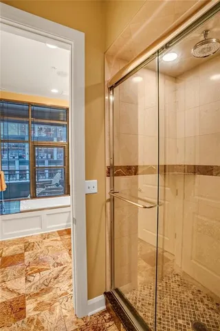 a bathroom with a shower and a window