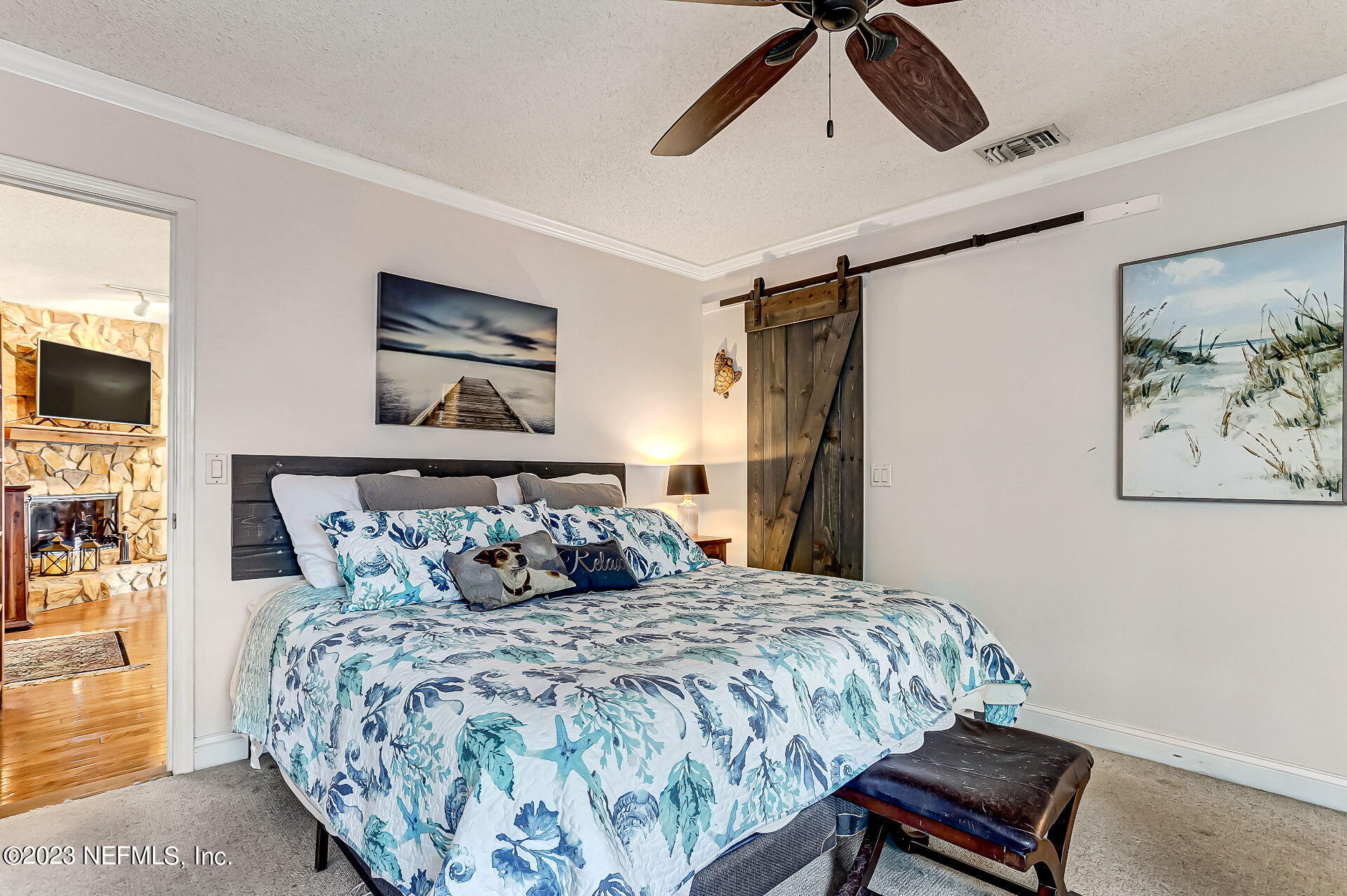 3866 Eunice Road Jacksonville, FL 32250 - Photo 11 of 41 a bedroom with a bed and a chandelier