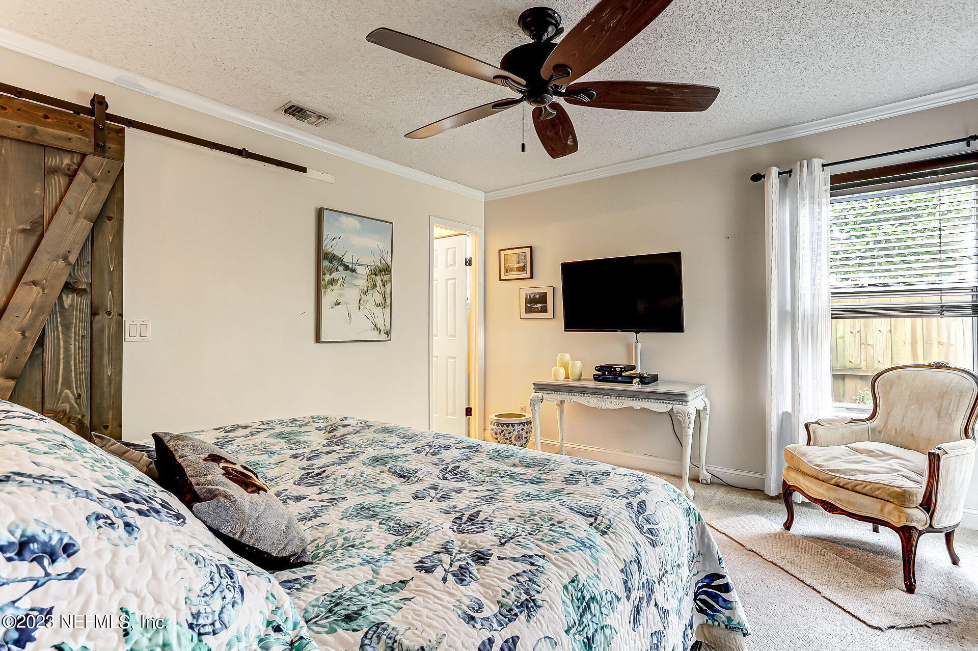 3866 Eunice Road Jacksonville, FL 32250 - Photo 12 of 41 a bedroom with a bed and a flat screen tv
