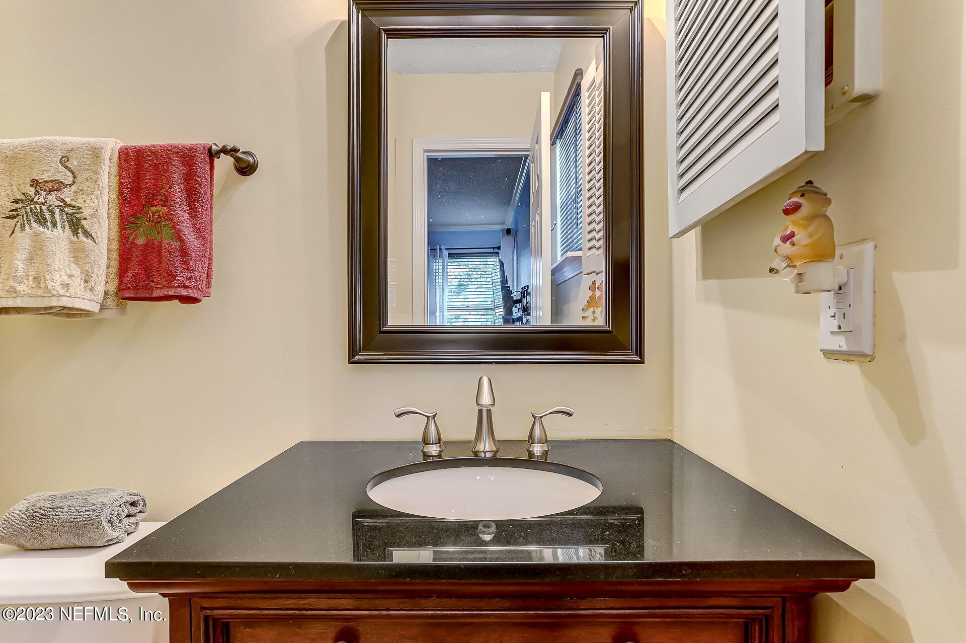 3866 Eunice Road Jacksonville, FL 32250 - Photo 16 of 41 a bathroom with a granite countertop sink and a mirror