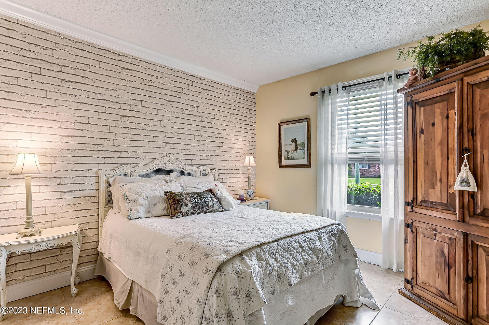 3866 Eunice Road Jacksonville, FL 32250 - Photo 17 of 41 a bedroom with a bed next to a window