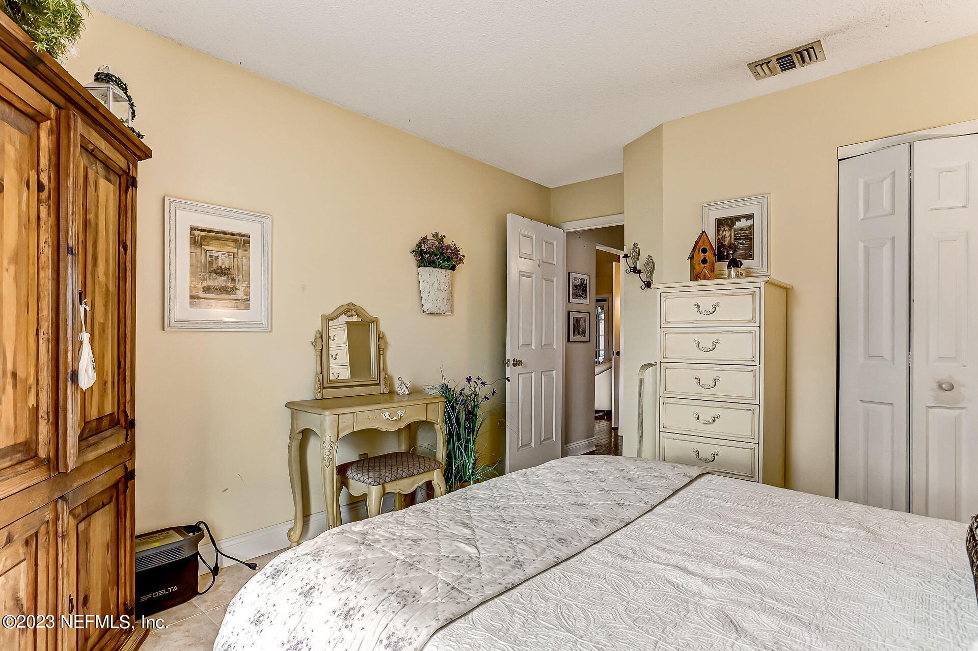 3866 Eunice Road Jacksonville, FL 32250 - Photo 19 of 41 a bedroom with a bed and a dresser