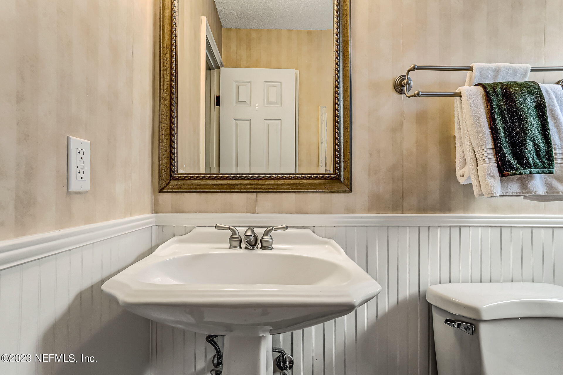 3866 Eunice Road Jacksonville, FL 32250 - Photo 20 of 41 a bathroom with a sink and a mirror