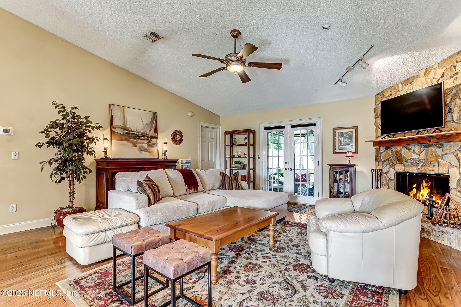 3866 Eunice Road Jacksonville, FL 32250 - Photo 3 of 41 a living room with furniture a flat screen tv and a fireplace