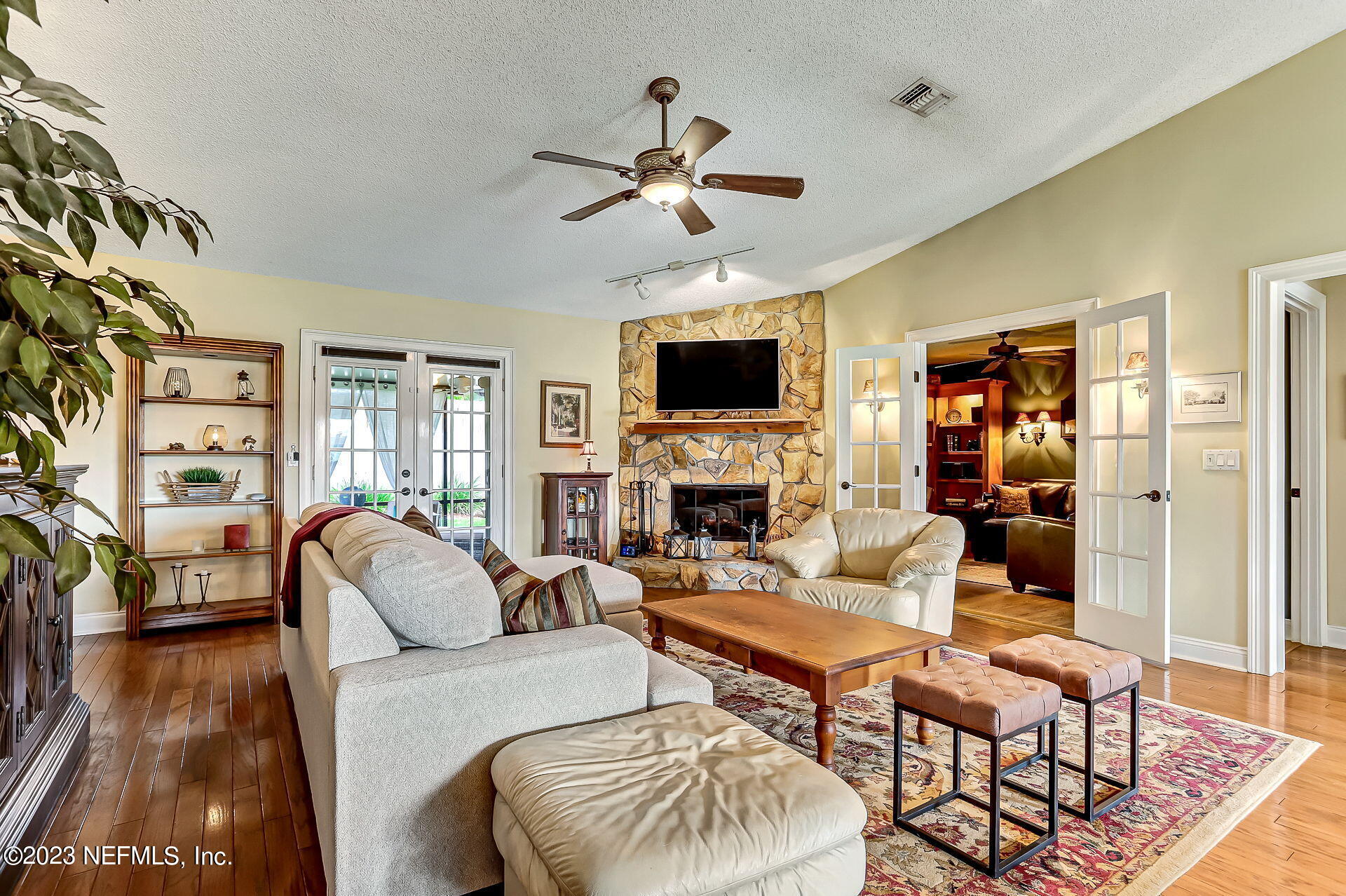 3866 Eunice Road Jacksonville, FL 32250 - Photo 4 of 41 a living room with furniture a fireplace and a flat screen tv