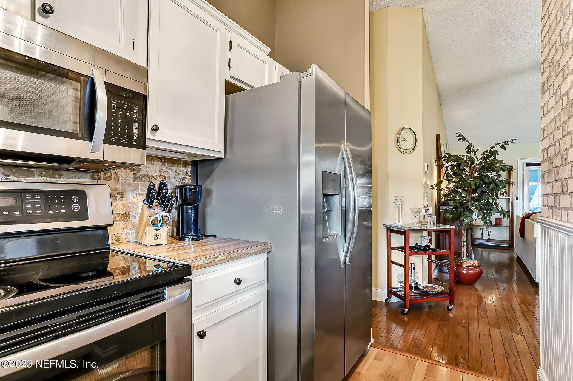 3866 Eunice Road Jacksonville, FL 32250 - Photo 8 of 41 a kitchen with stainless steel appliances a stove a refrigerator and a fireplace