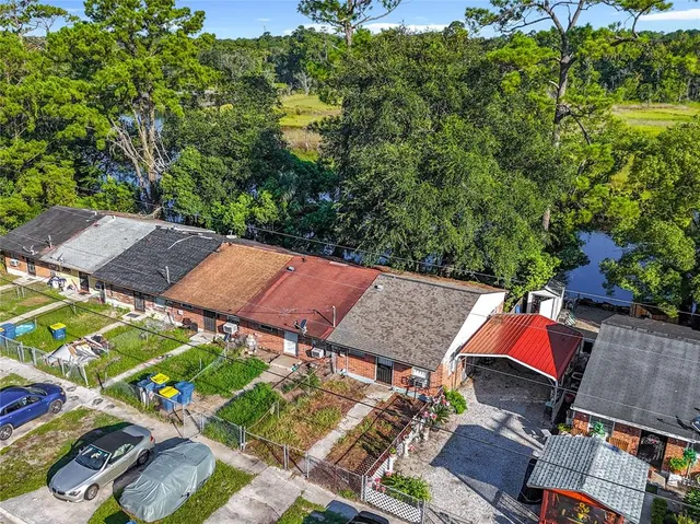 an aerial view of a house with garden space and street view