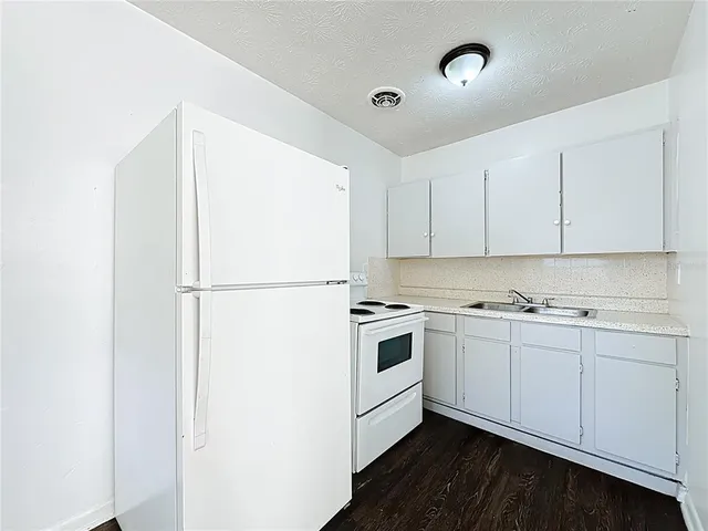 a kitchen with a sink a stove and refrigerator
