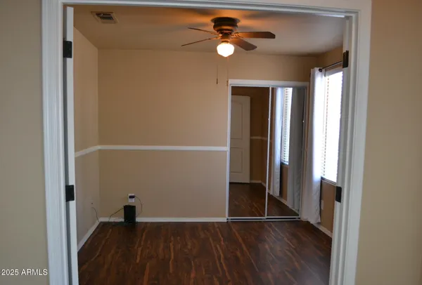 a view of hallway with a large window and wooden floor