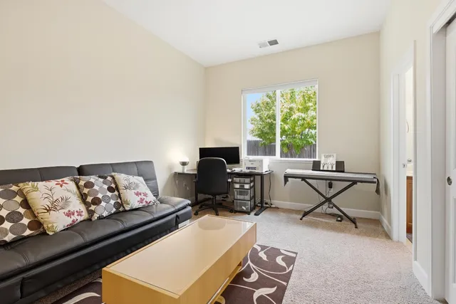 a living room with furniture a window and a flat screen tv