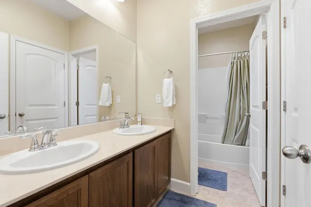 a bathroom with a double vanity sink and a mirror