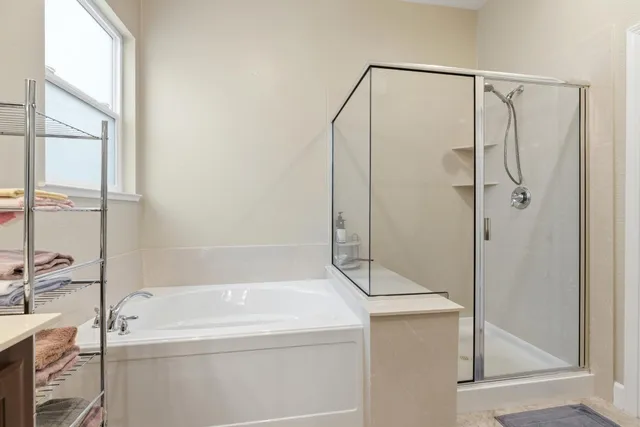 a bathroom with a tub and a shower