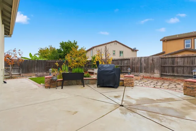 a view of a chairs and tables in the back yard of the house