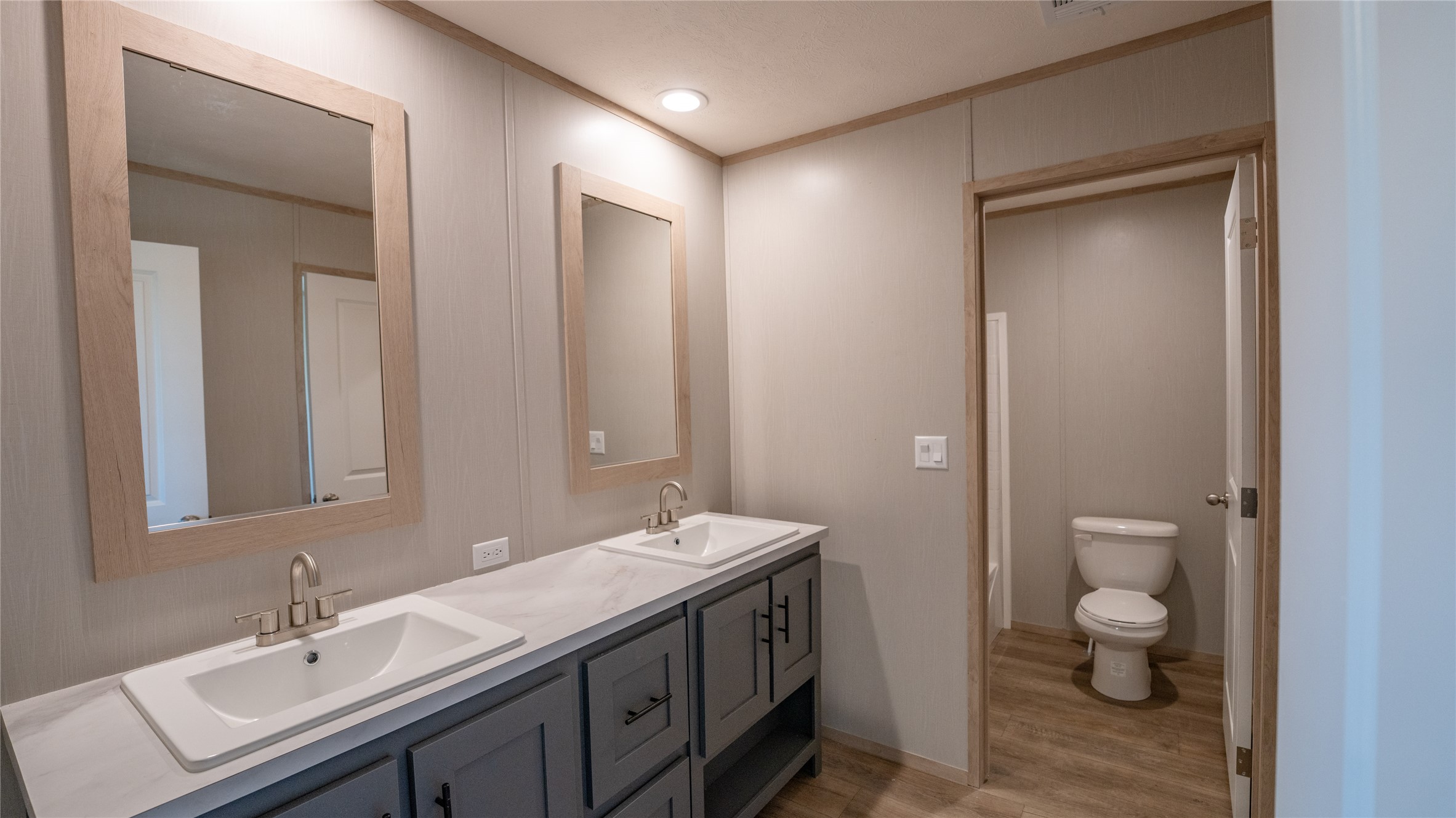 1145 Callihan Road Luling, TX 78648 - Photo 13 of 39 Bathroom featuring wood finished floors, double vanity, and crown molding