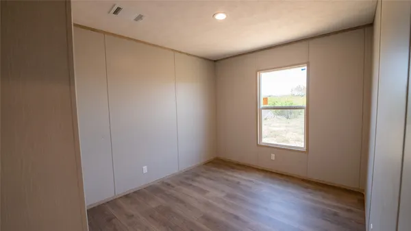 a view of hallway with wooden floor