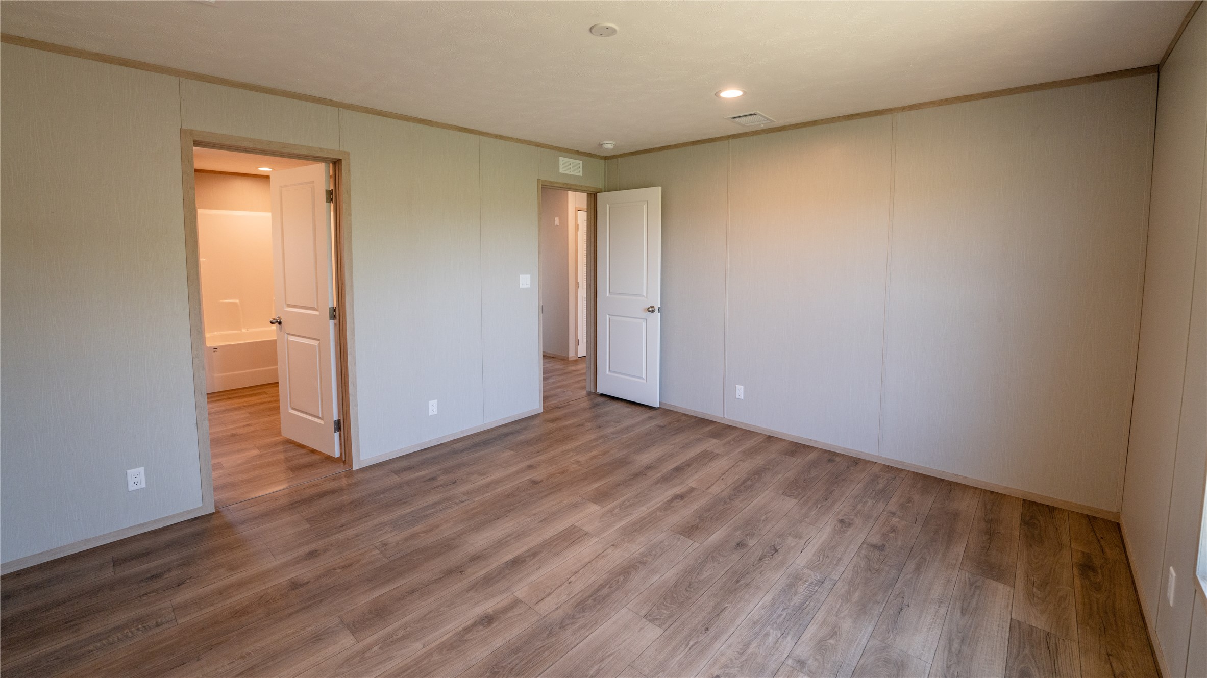 1145 Callihan Road Luling, TX 78648 - Photo 28 of 39 Spare room with crown molding, wood finished floors, and recessed lighting