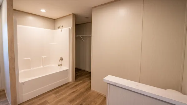 a bathroom with a double vanity sink a mirror and a bathtub