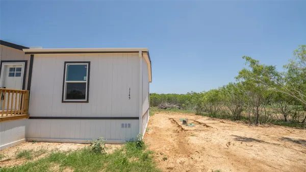 a view of a backyard of the house