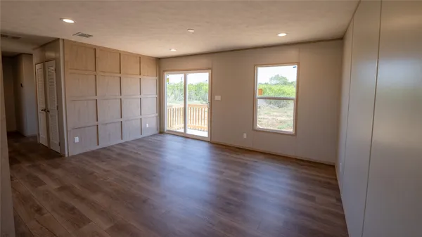 a view of hallway with wooden floor