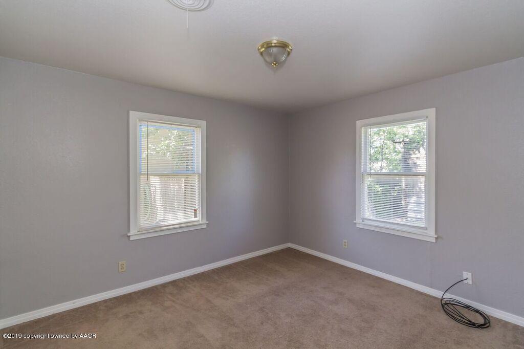 4308 South Travis Street Amarillo, TX 79110 - Photo 18 of 32 a view of an empty room with a window
