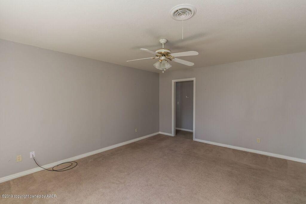 4308 South Travis Street Amarillo, TX 79110 - Photo 4 of 32 a view of an empty room with a chandelier fan