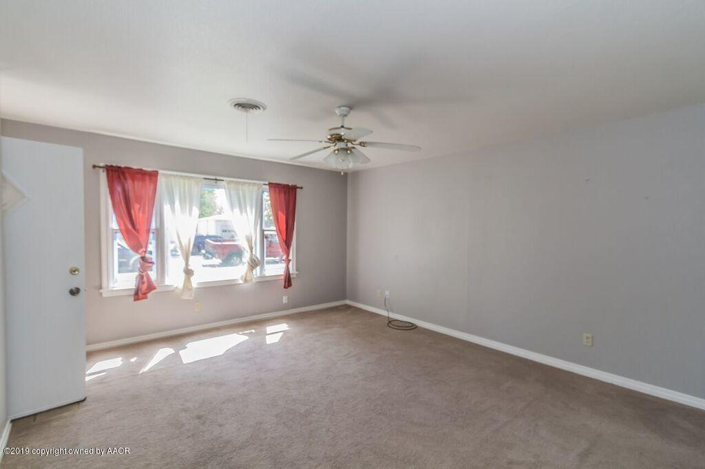 4308 South Travis Street Amarillo, TX 79110 - Photo 6 of 32 an empty room with a empty space and windows