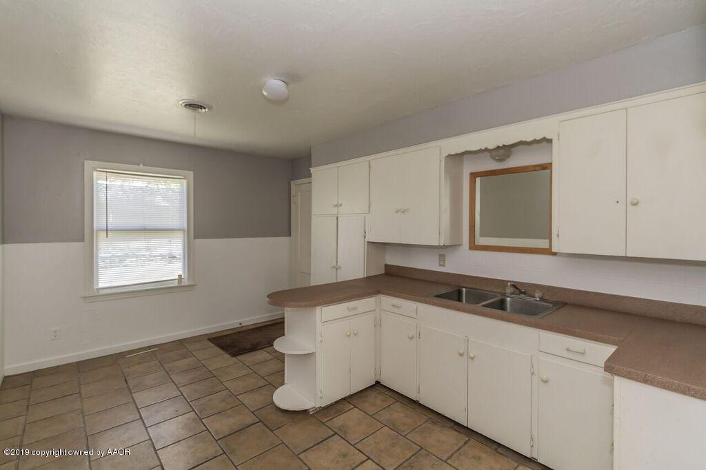 4308 South Travis Street Amarillo, TX 79110 - Photo 7 of 32 a bathroom with a sink and a mirror