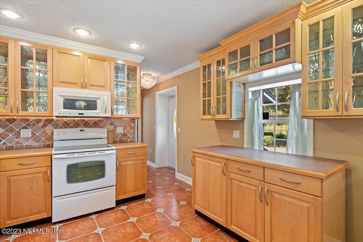 3048 Stratton Lane Jacksonville, FL 32221 - Photo 14 of 41 a kitchen with stainless steel appliances granite countertop a stove a sink and a microwave oven