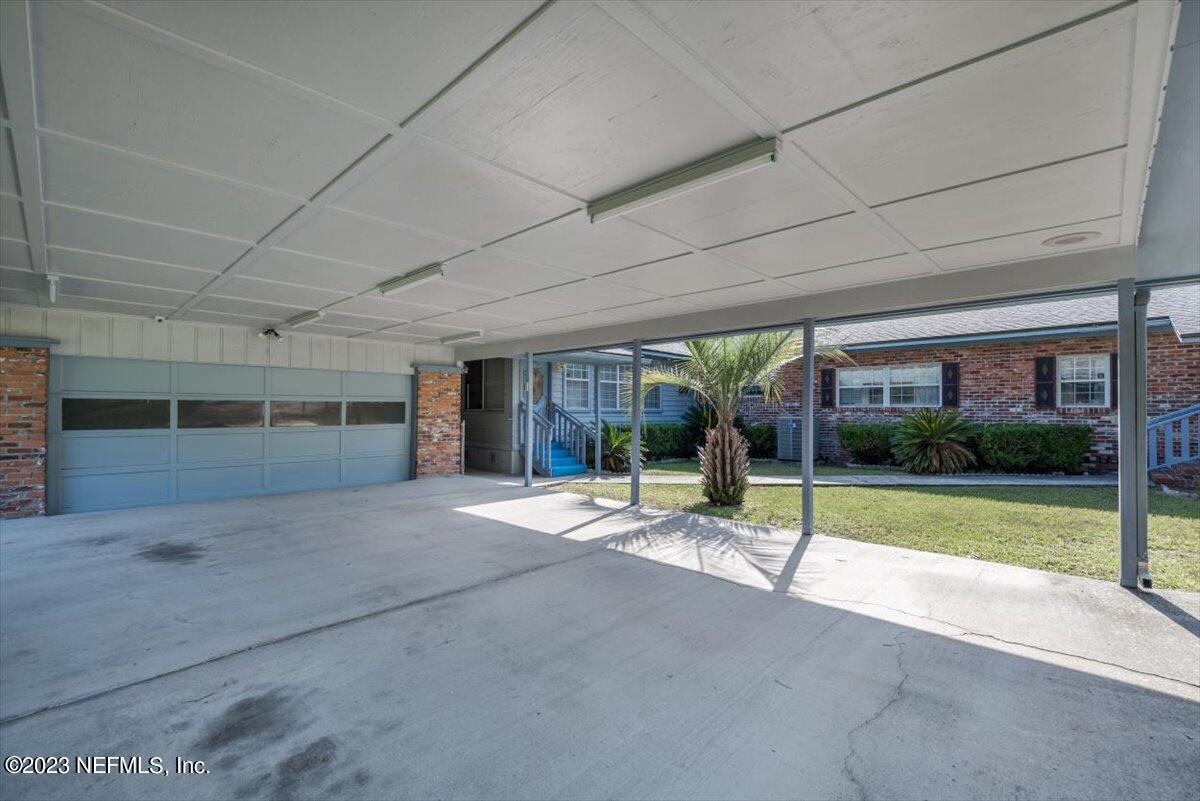 3048 Stratton Lane Jacksonville, FL 32221 - Photo 35 of 41 a view of a patio with a table and chairs and floor to ceiling window
