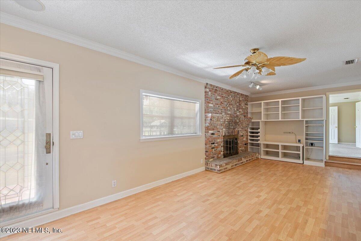 3048 Stratton Lane Jacksonville, FL 32221 - Photo 9 of 41 an empty room with windows and a ceiling fan