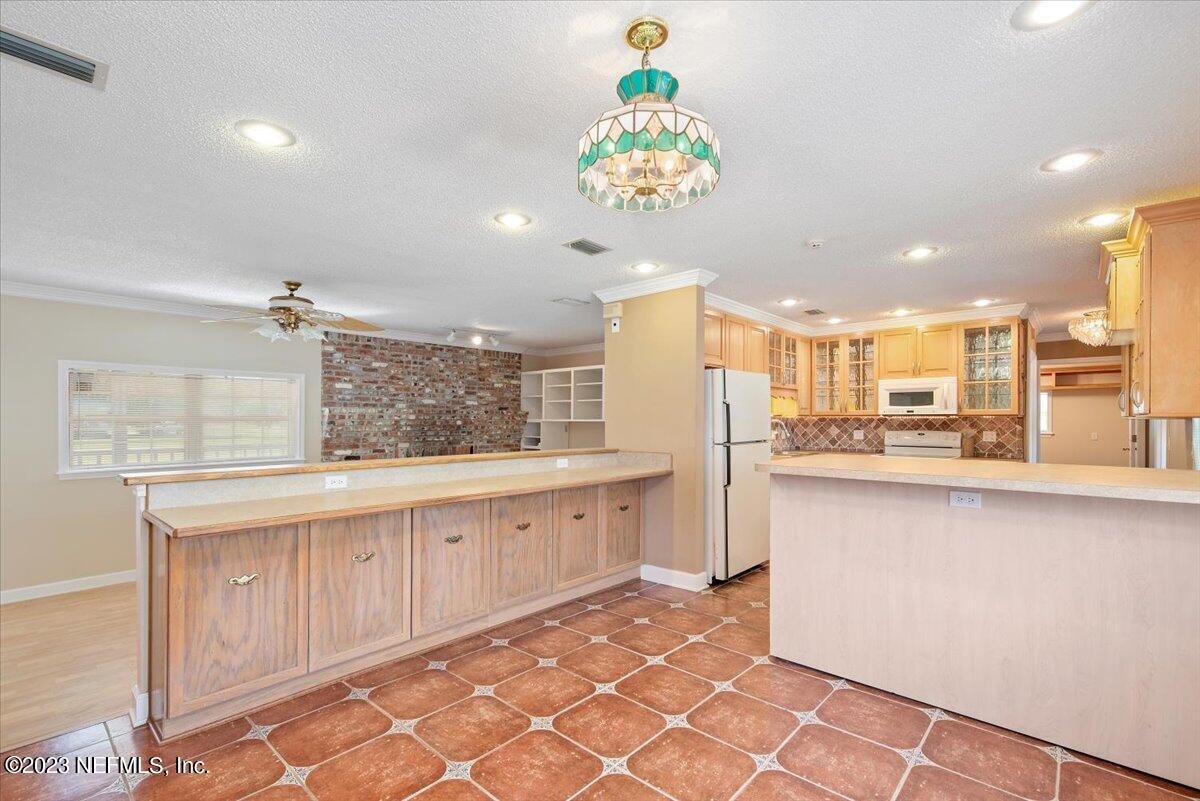 3048 Stratton Lane Jacksonville, FL 32221 - Photo 10 of 41 a large kitchen with kitchen island granite countertop a large counter top and sink