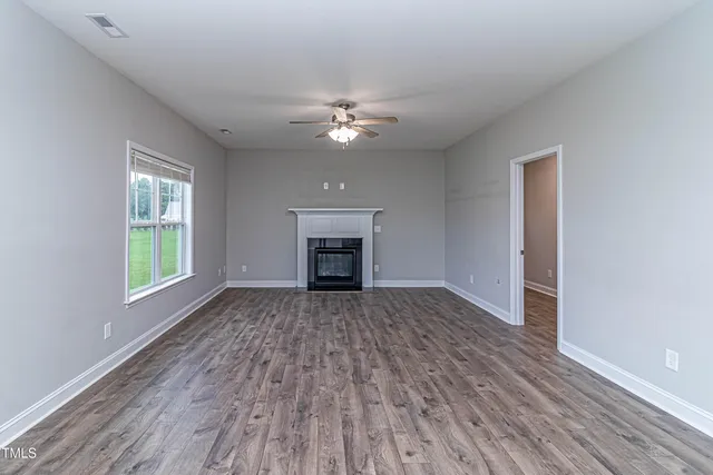 a living room with furniture fireplace and a flat screen tv