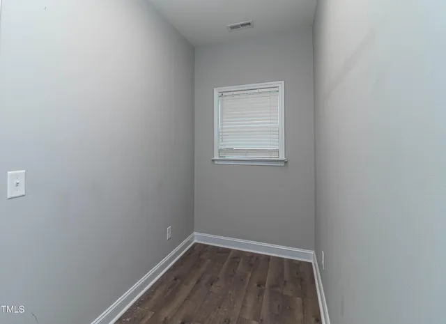 a view of a kitchen with furniture a ceiling fan and wooden floor