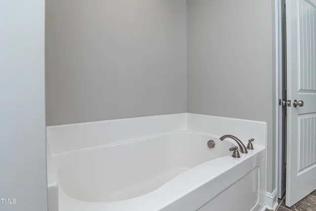 a bathroom with a sink vanity a mirror and a light fixture