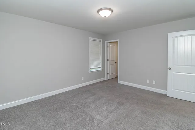 a bedroom with a bed and a chair