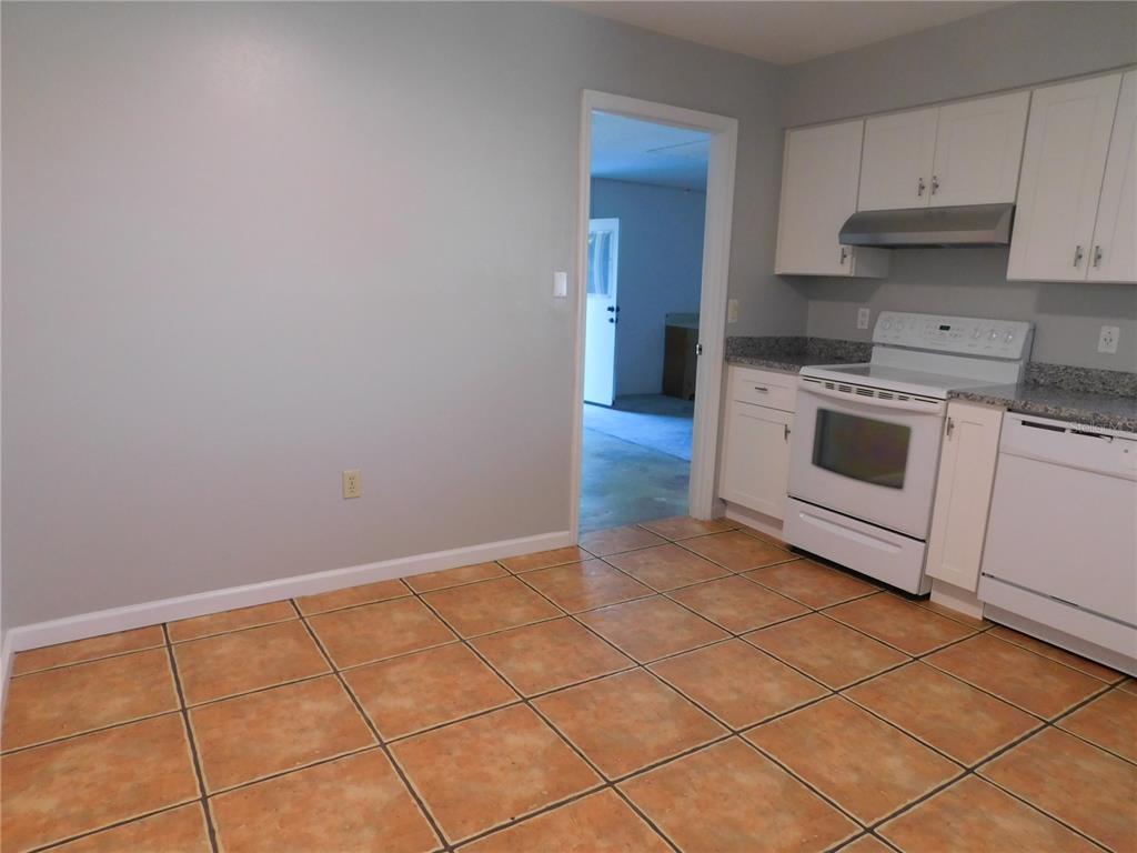 508 65th Avenue West Bradenton, FL 34207 - Photo 14 of 33 a kitchen with a stove top oven and cabinets