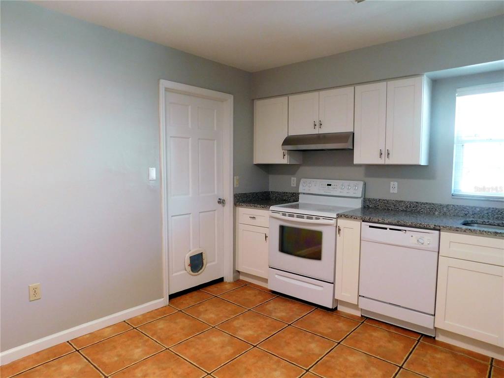 508 65th Avenue West Bradenton, FL 34207 - Photo 17 of 33 a kitchen with white cabinets and white appliances