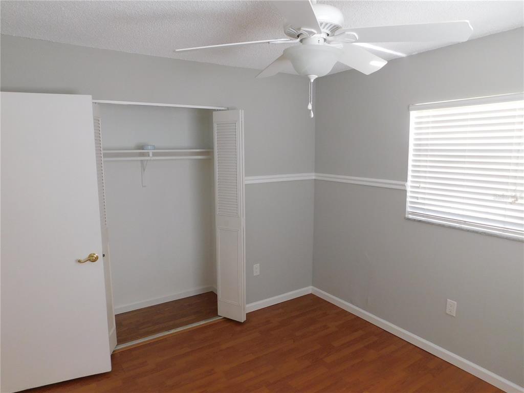 508 65th Avenue West Bradenton, FL 34207 - Photo 21 of 33 an empty room with windows and fan
