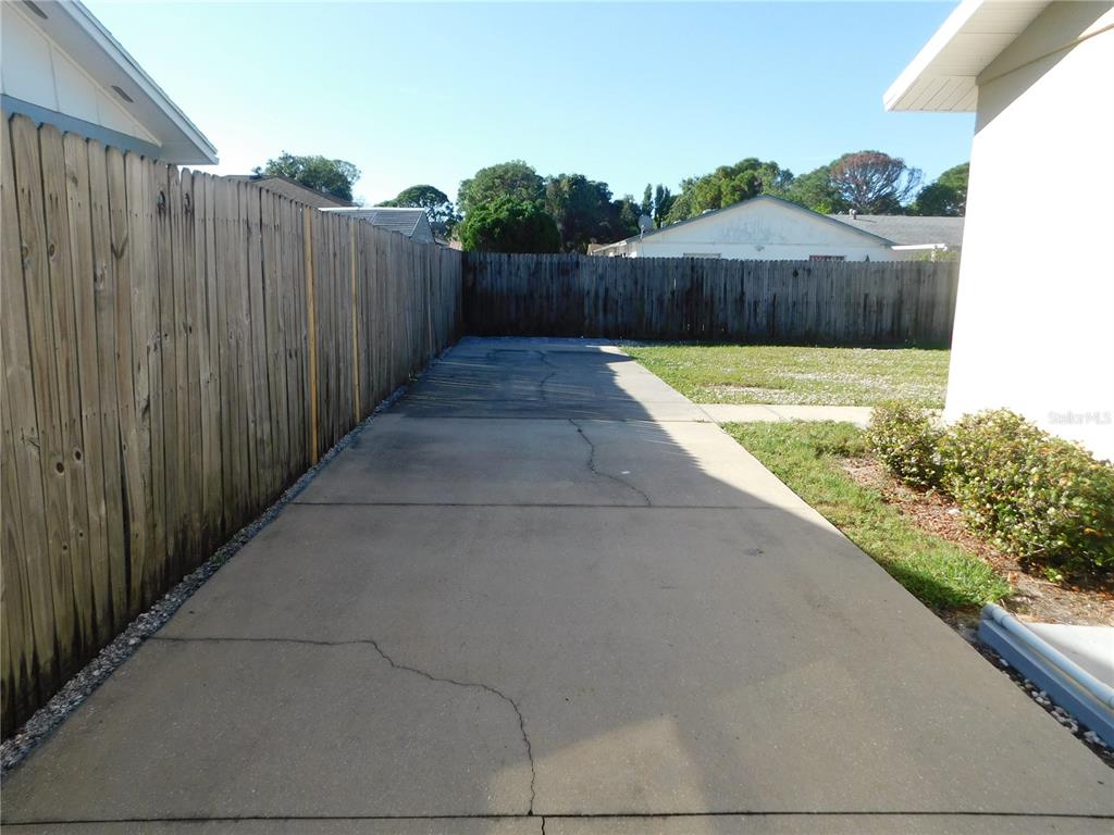 508 65th Avenue West Bradenton, FL 34207 - Photo 23 of 33 a view of a backyard with a wooden fence