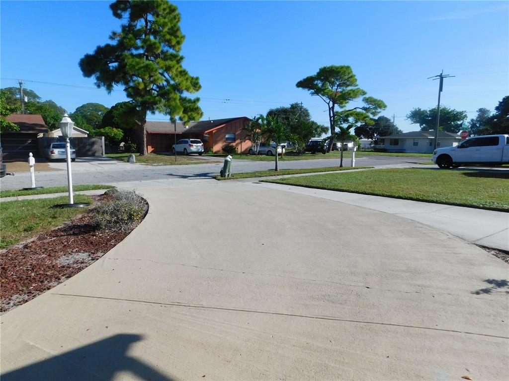 508 65th Avenue West Bradenton, FL 34207 - Photo 33 of 33 a front view of a house with a yard and palm trees