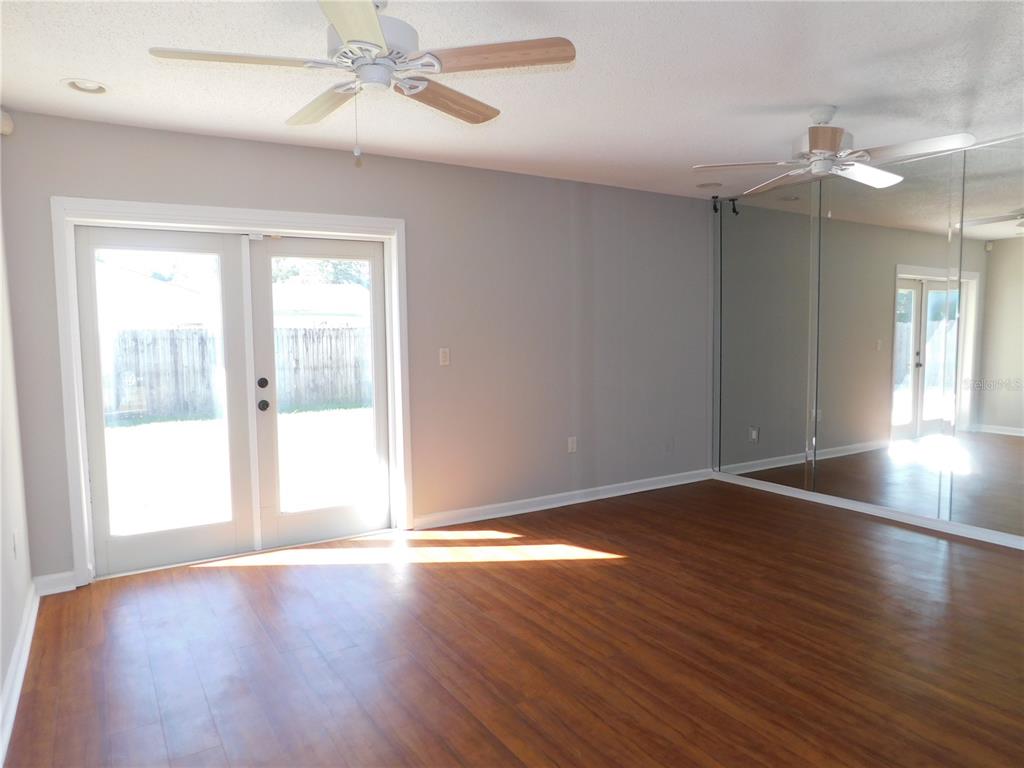 508 65th Avenue West Bradenton, FL 34207 - Photo 4 of 33 a view of an empty room with wooden floor and a window