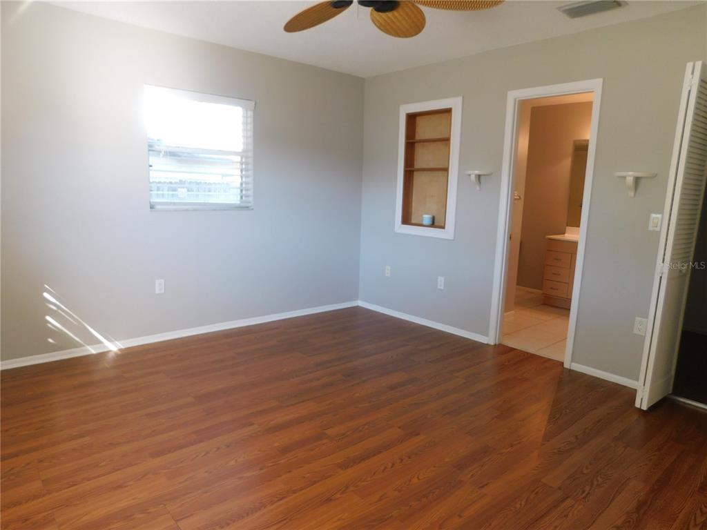 508 65th Avenue West Bradenton, FL 34207 - Photo 8 of 33 a view of an empty room with wooden floor and a window