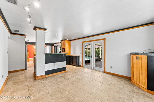 a view of a yard with plants and a bench