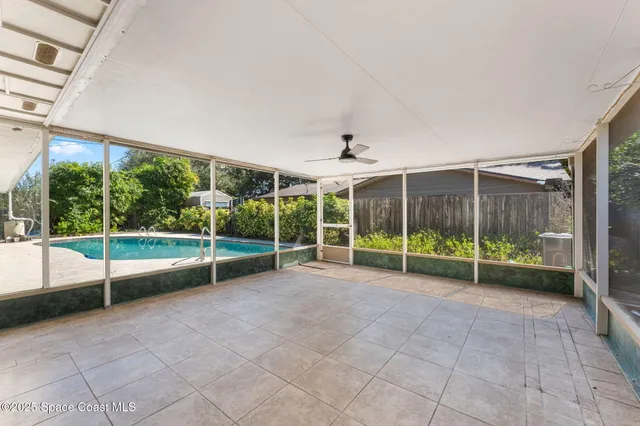 a view of a swimming pool with a chairs and a table