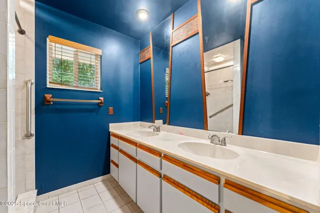 a bathroom with a double vanity sink a and a mirror