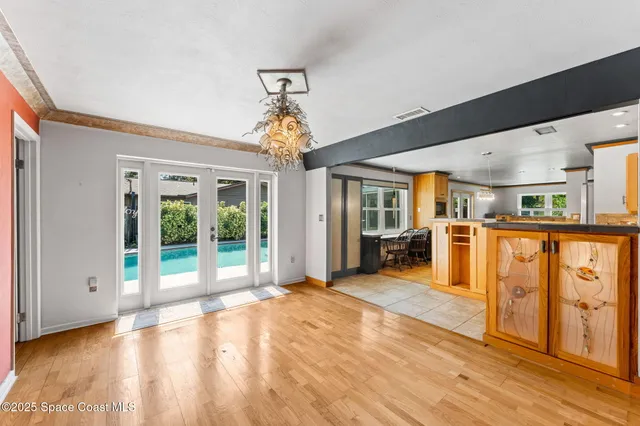 a view of small space with wooden floor and a window